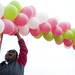 A volunteer holds up the balloon finish line and cheers on Sunday. Daniel Brenner I AnnArbor.com